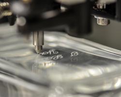 Rotary engraving on a glass perfume bottle for personalized cosmetic branding