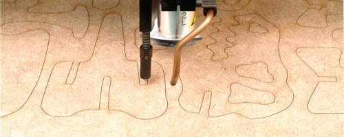 Wooden dinosaur parts being cut using a laser wood cutting machine