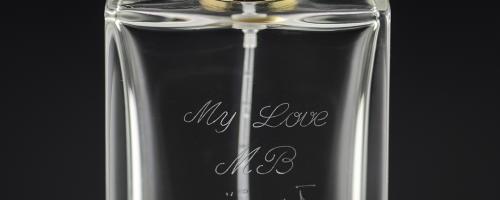 Perfume engraving with a custom love message on a clear glass perfume bottle