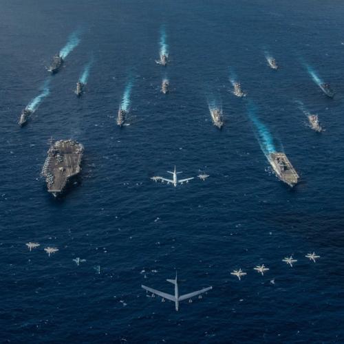 Composition of aircrafts and war ships on a sea background